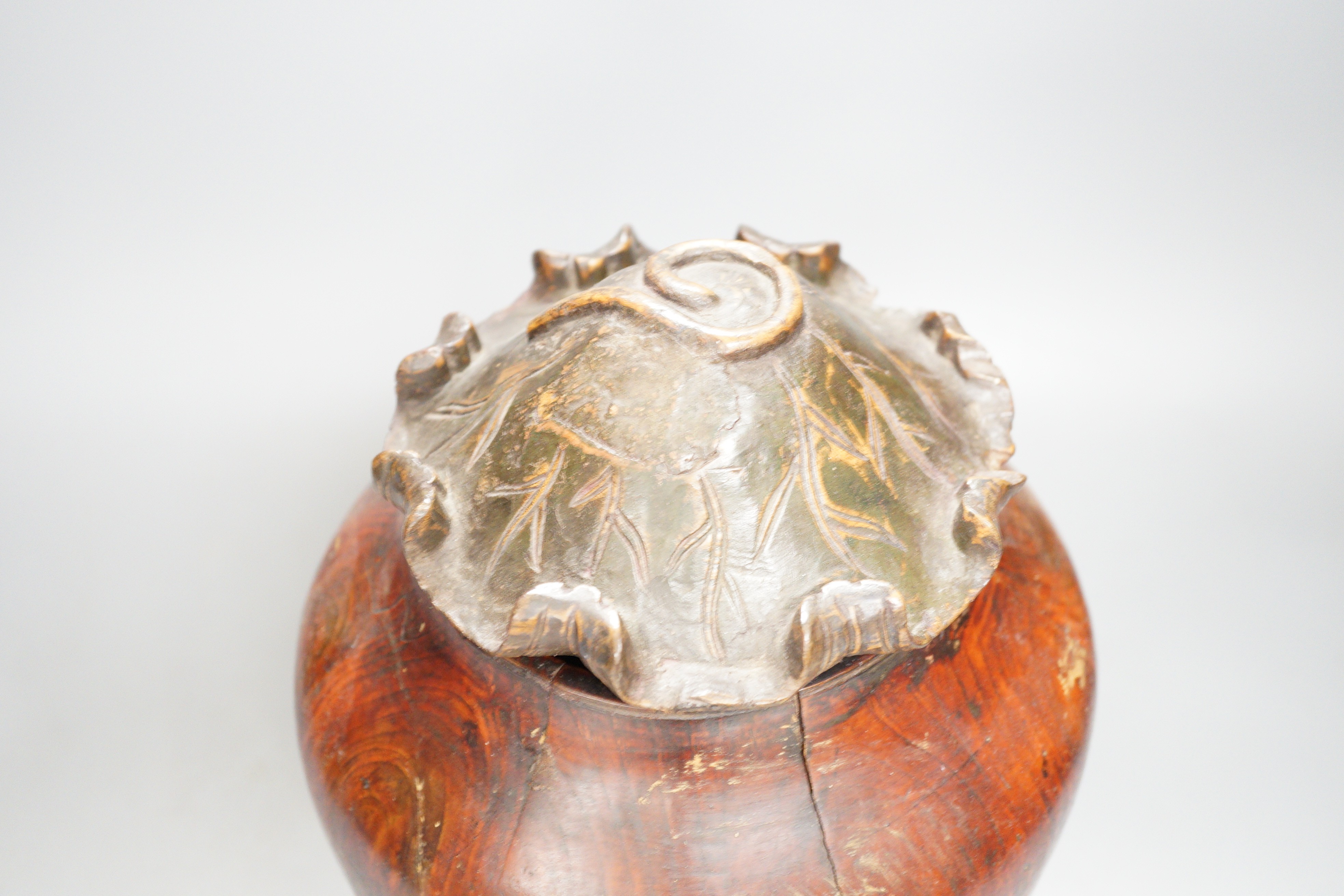A Chinese carved wood jar and cover, 33cm